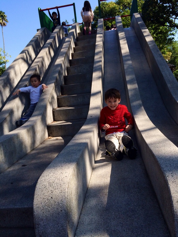 Children playing on a slide at a park